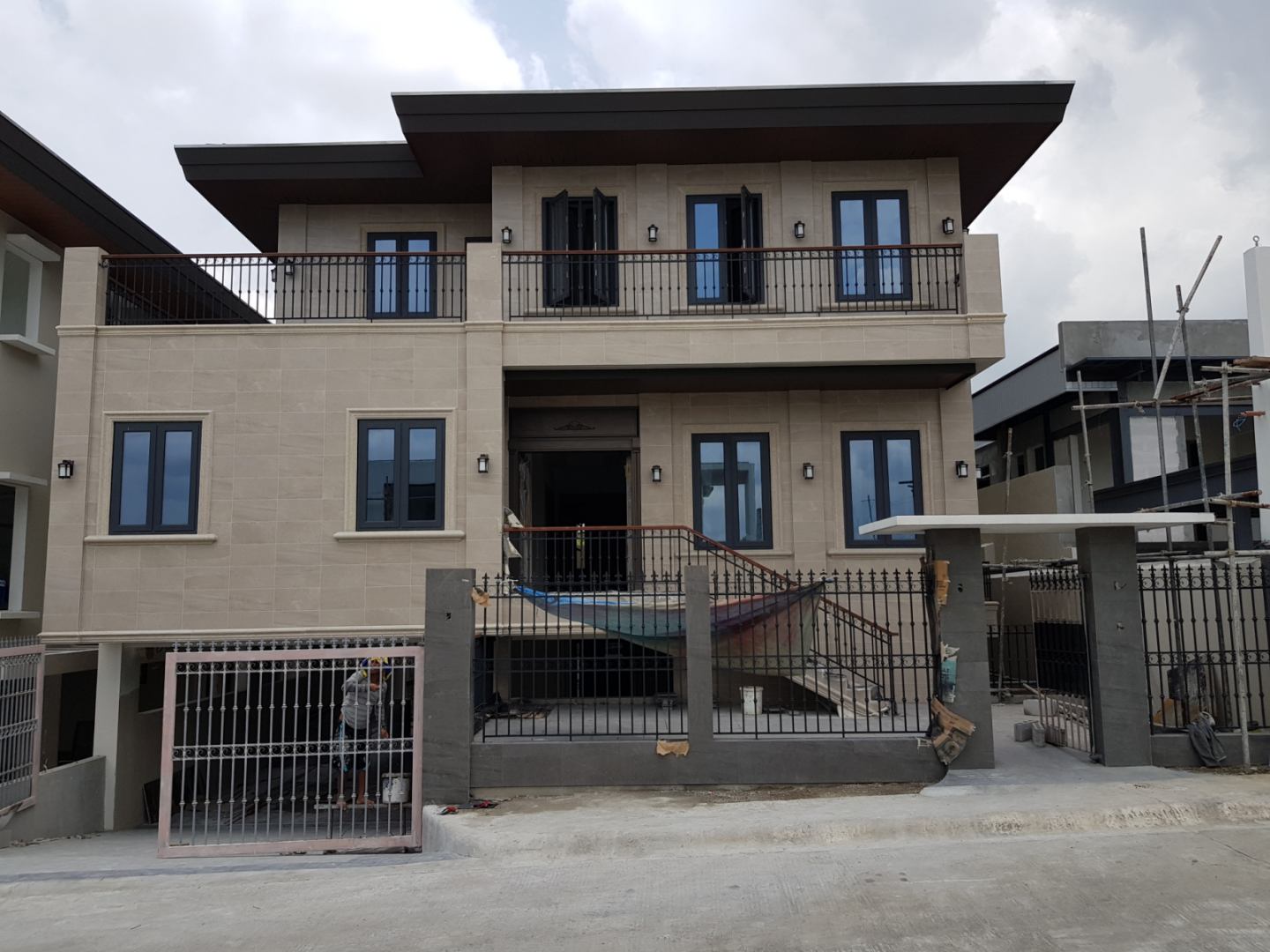 Two-story residential house with aluminum window and gate installation